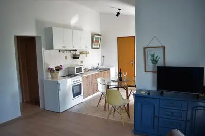 a kitchen with a table and a white stove top oven at Lovely 1BR Apartment 5min of walk from city center in Bar