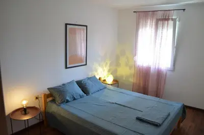 a bedroom with a blue bed and a window at Lovely 1BR Apartment 5min of walk from city center in Bar