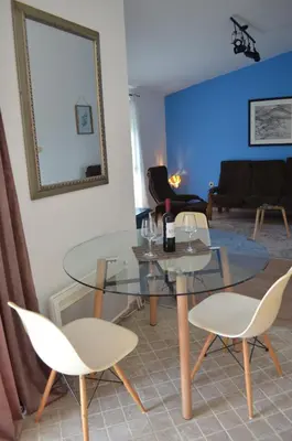 a living room with a glass table and chairs at Lovely 1BR Apartment 5min of walk from city center in Bar