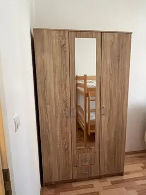 a wooden door with a mirror in a room at B&V apartmani in Bar, Susanj