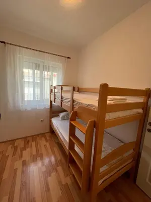 a room with two bunk beds and a window at B&V apartmani in Bar, Susanj