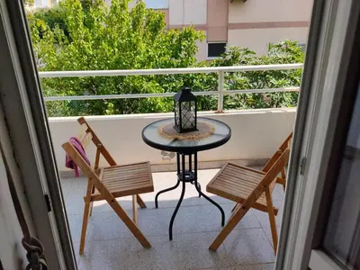 a table and two chairs on a balcony at MiNa Apartments in Petrovac na Moru