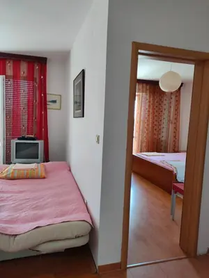 a bedroom with a bed and a television in it at MiNa Apartments in Petrovac na Moru