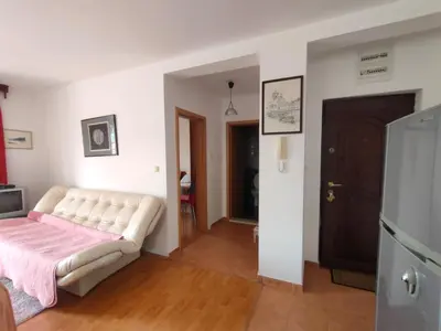 a living room with a white couch in a room at MiNa Apartments in Petrovac na Moru