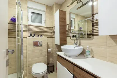 a bathroom with a sink and a toilet and a shower at Budva Olive Escape in Budva