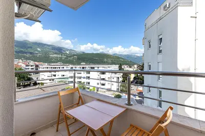 a balcony with two chairs and a table and a view at Budva Olive Escape in Budva