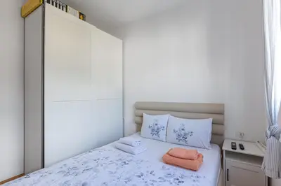 a bedroom with a bed with two towels on it at Budva Olive Escape in Budva