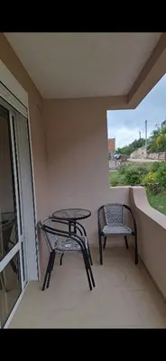 a patio with a table and two chairs on a balcony at Apartmani Madžgalj Sutomore in Sutomore