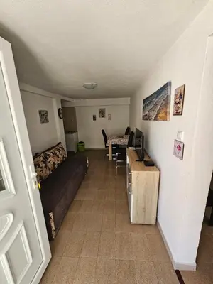 a living room with a couch and a bed and a desk at Vila Lučica apartman u prizemlju in Petrovac na Moru