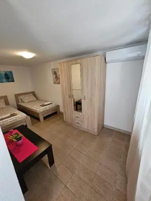 a living room with a couch and a table at Vila Lučica apartman u prizemlju in Petrovac na Moru