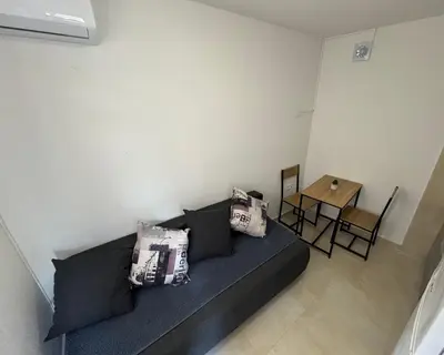 a living room with a couch and a table at Apartments Tripoint Kotor in Kotor