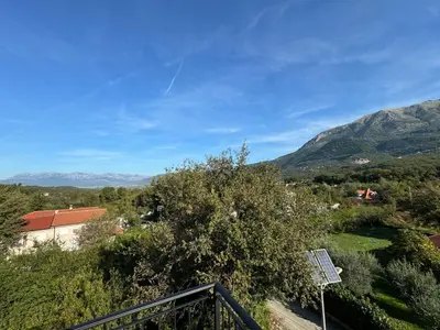 a view of the mountains from a balcony at Apartments Tripoint Kotor in Kotor