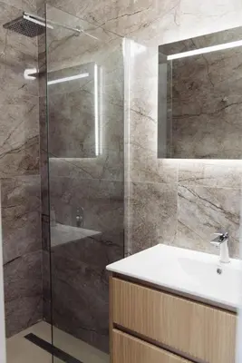 a bathroom with a shower with a sink and a mirror at Home of Sveti Stefan in Sveti Stefan