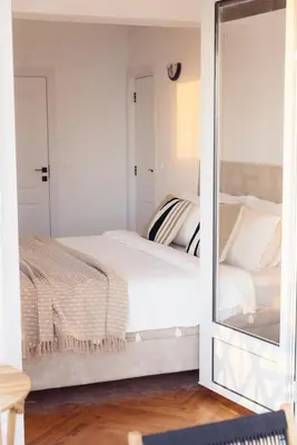 a bedroom with a bed and a mirror at Home of Sveti Stefan in Sveti Stefan