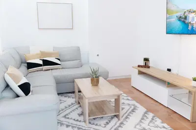 a living room with a couch and a table at Home of Sveti Stefan in Sveti Stefan