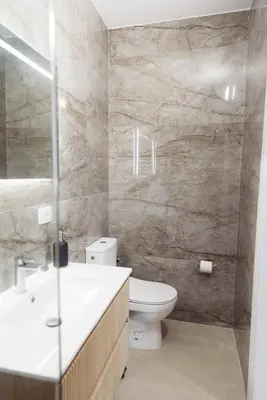 a bathroom with a toilet and a sink and a shower at Home of Sveti Stefan in Sveti Stefan