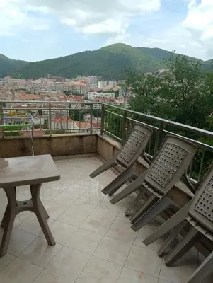 two chairs and a table on a balcony with a view at Vila Teodora in Budva