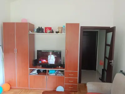 a living room with a tv in a wooden entertainment center at Vila Teodora in Budva