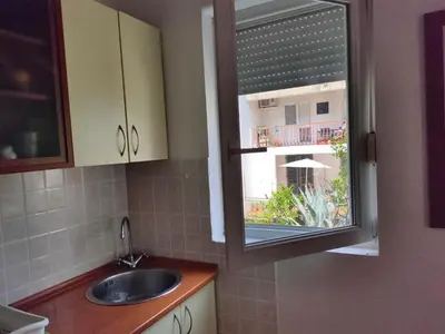 a kitchen with a sink and a window at MiNa Studio Petrovac in Petrovac na Moru
