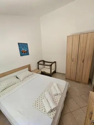 a bedroom with a bed with two towels on it at Vila Lučica apartman 2 pogled planina in Petrovac na Moru