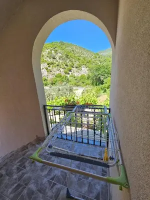 a room with a staircase with a view of a mountain at Vila Lučica apartman 2 pogled planina in Petrovac na Moru