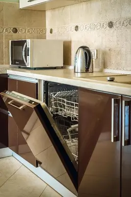 a dishwasher in a kitchen with a microwave at Luxury Apartments Rafailovichi 1 st of the sea line in Rafailovici