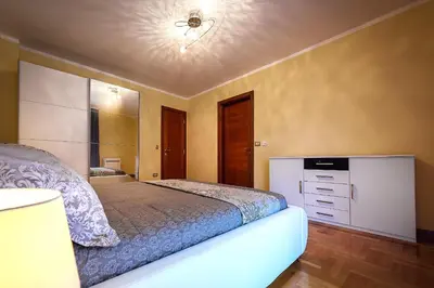 a bedroom with a bed and a ceiling at Luxury Apartments Rafailovichi 1 st of the sea line in Rafailovici
