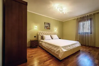 a bedroom with a large bed and a window at Luxury Apartments Rafailovichi 1 st of the sea line in Rafailovici