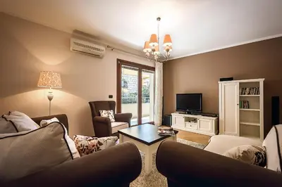 a living room with two couches and a tv at Luxury Apartments Rafailovichi 1 st of the sea line in Rafailovici