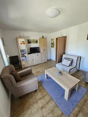 a living room with a couch and a coffee table at Vila Lučica apartman pogled na more in Petrovac na Moru