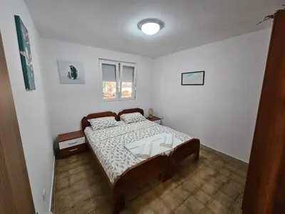 a bedroom with a bed in a room at Vila Lučica apartman pogled na more in Petrovac na Moru
