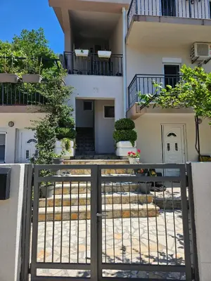 a building with a gate in front of it at Vila Lučica apartman pogled na more in Petrovac na Moru
