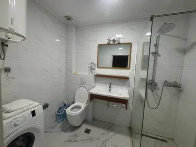 a bathroom with a toilet and a sink and a shower at Apartman Sofija in Ulcinj