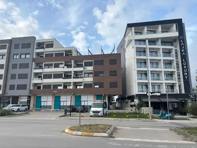 a building with a van parked in front of it at Apartman Sofija in Ulcinj