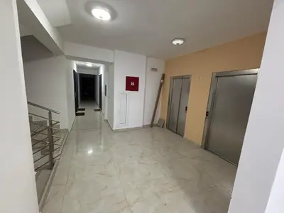 an empty hallway of a building with doors and floors at Apartman Sofija in Ulcinj