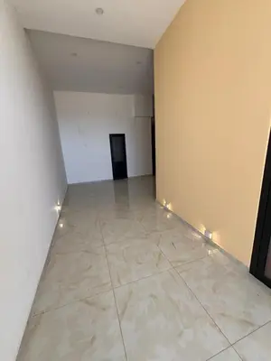 an empty room with a white wall and a tile floor at Apartman Sofija in Ulcinj