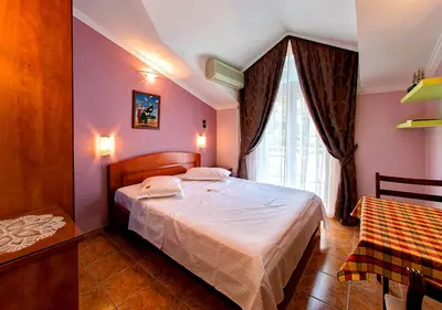 a bedroom with a bed and a window at Vila Koral in Petrovac na Moru