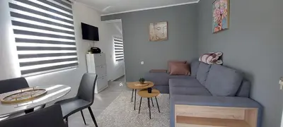 a living room with a blue couch and a table at Nika house in Cetinje