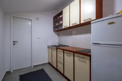 a kitchen with white cabinets and a white refrigerator at Nika house in Cetinje