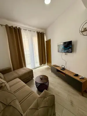 a living room with a couch and a table at Morski kutak in Sutomore