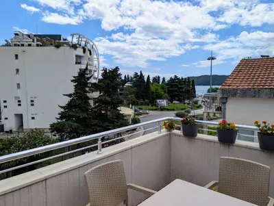 a balcony with chairs and a view of a street at Apartment Bjanka in Budva