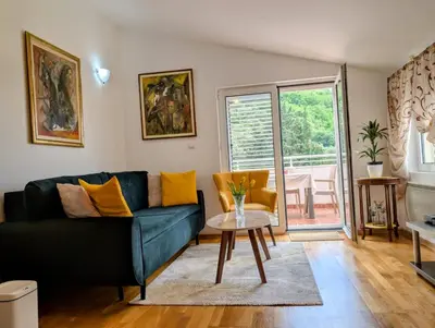 a living room with a couch and a table at Apartment Bjanka in Budva