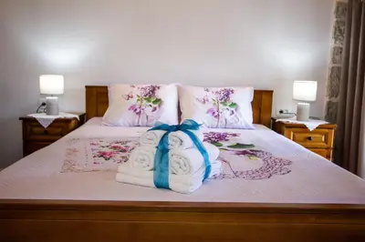 a bed with towels and pillows on it at Apartmani Stone oasis in Zupci