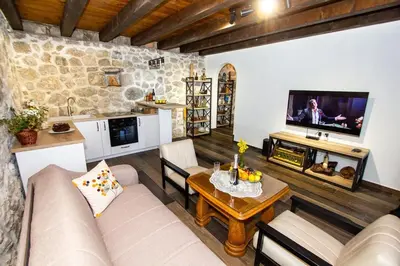 a living room with a couch and a table at Apartmani Stone oasis in Zupci