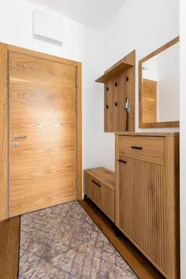 a bathroom with a wooden door and a mirror at Adriatic Harmony in Bar
