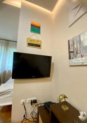 a living room with a flat screen tv on the wall at City Center 1 in Podgorica