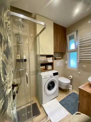 a bathroom with a washing machine and a toilet at City Center 1 in Podgorica