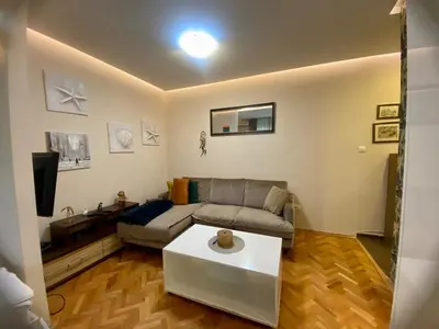 a living room with a couch and a coffee table at City Center 1 in Podgorica