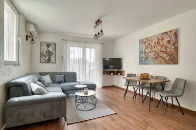 a living room with a couch and a table at Sea Elegance Rafailovici in Rafailovici