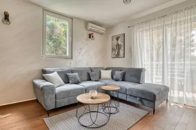 a living room with a couch and a table at Sea Elegance Rafailovici in Rafailovici